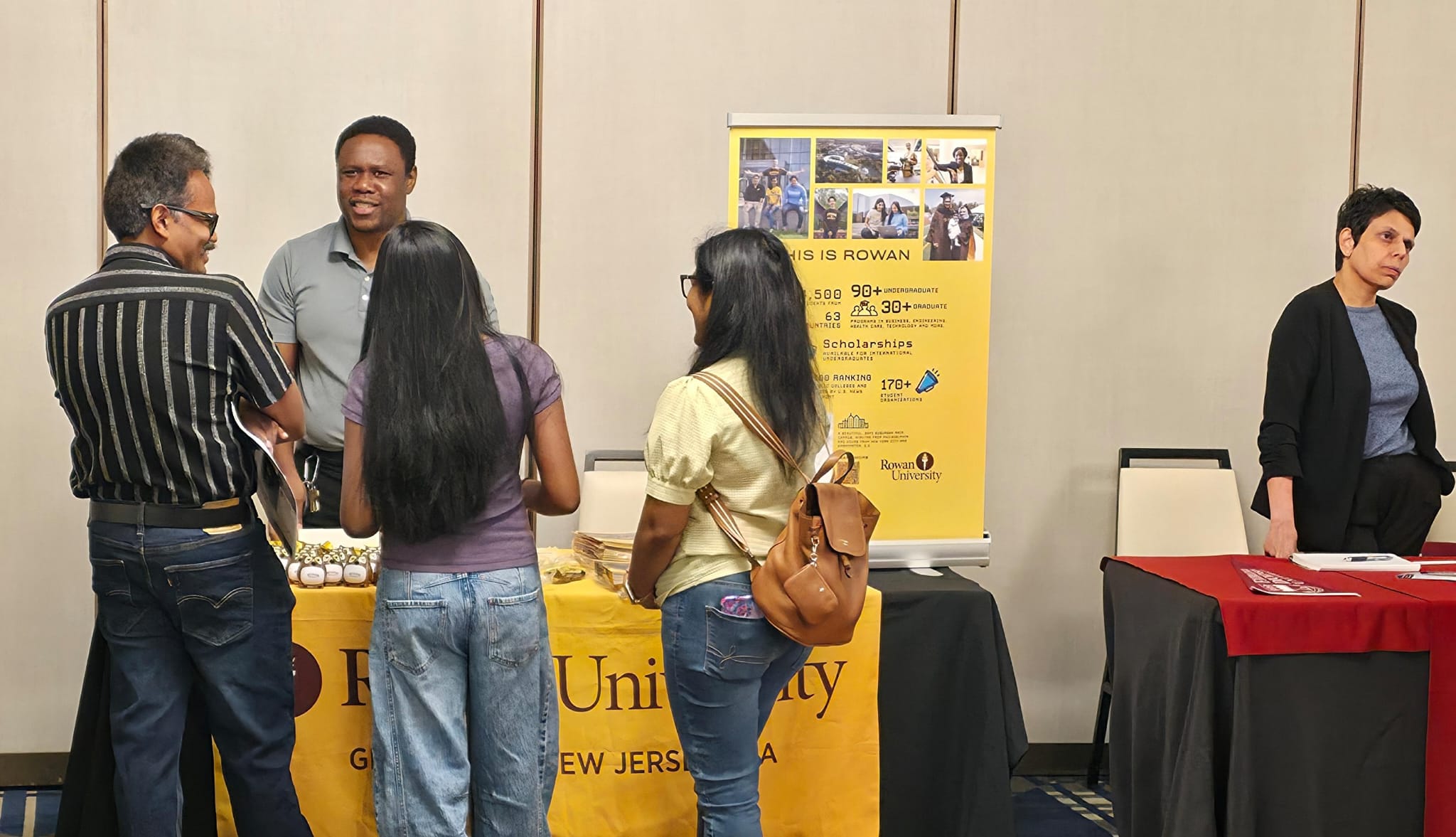 Families and students speaking with university representatives at the PATH 2026 college readiness day in Edison, NJ